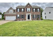 Traditional two-story brick home with a well-manicured lawn and attached two-car garage at 5571 Auburndale Dr, Bargersville, IN 46106
