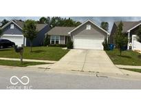 Charming single-story home featuring a well-maintained lawn and an attached two-car garage at 6926 Trey Dr, Indianapolis, IN 46113