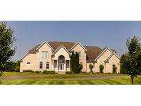 Stately two-story home with light brick exterior and manicured front lawn at 7493 W Lane Rd, McCordsville, IN 46055