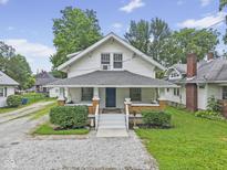 Charming two-story home with a inviting front porch and landscaped yard at 113 N Munsie St, Indianapolis, IN 46229