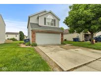 Charming two-story home with a gray exterior, brick accents, and a spacious two-car garage at 11532 Glenn Abbey Ln, Indianapolis, IN 46235