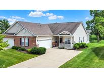 Charming single-story home with a well-manicured lawn, attached garage, and inviting front porch at 1163 Meadowlark Dr, Greenwood, IN 46143