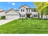 Charming two-story home features a well-manicured lawn, attached garage, and traditional architectural details at 12234 Limestone Dr, Fishers, IN 46037