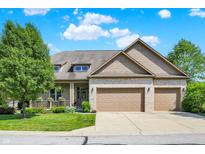 Charming brick home with a two-car garage, well-manicured lawn, and inviting front porch at 15529 Mission Hills Dr, Carmel, IN 46033