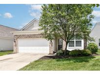 Charming single-Gathering home with a brick facade, a well-maintained lawn, and a two-car garage at 15946 Marsala Dr, Fishers, IN 46037