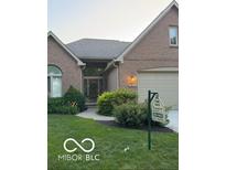 Charming brick home featuring a well-manicured lawn and inviting front entrance, perfect for a Gathering at 1870 Broadleaf Ct # 10, Greenwood, IN 46143