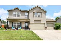 Charming two-story home with a well-manicured lawn, inviting front porch, and a convenient two-car garage at 2020 Treving Dr, Cicero, IN 46034