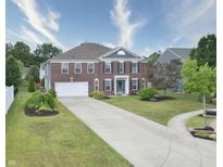 Beautiful brick two-story home with a manicured lawn, long driveway, and attached two-car garage at 21491 Raccoon Ct, Noblesville, IN 46062