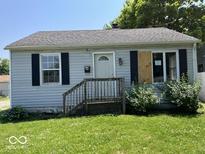 Charming single-story home with light blue siding and black shutters shows potential at 2507 S Keystone Ave, Indianapolis, IN 46203