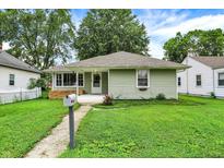 Inviting exterior showcasing a well-maintained yard and a welcoming front porch at 26 E Plum St, Anderson, IN 46012