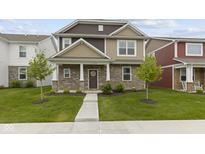 Charming two-story home with stone and siding, featuring a well-manicured lawn and inviting front porch at 2733 Lamar Dr, Whitestown, IN 46075