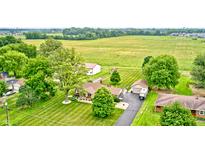 Sprawling property featuring a charming home, lush greenery, and a spacious yard at 333 N Windswept Rd, Greenfield, IN 46140