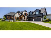 Beautiful home with stone and black accents, three-car garage and professionally landscaped yard at 3675 Dartmoor Way, Zionsville, IN 46077