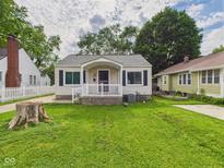 Charming home with a well-maintained lawn and a cozy front porch at 4025 Main St, Anderson, IN 46013