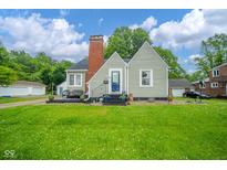 Charming home with a classic design, landscaped lawn, and inviting front porch at 4210 Main St, Anderson, IN 46013