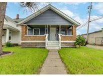 Charming home featuring a cozy front porch, well-maintained lawn, and inviting curb appeal at 517 N Alton Ave, Indianapolis, IN 46222