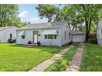 Charming single-story home features a well-manicured lawn, driveway, and tidy landscaping at 524 S Arlington Ave, Indianapolis, IN 46219