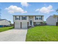 Charming two-story home with a well-manicured lawn, double garage, and blue shuttered windows at 5503 Antoneli Ln, Indianapolis, IN 46237