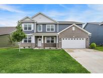 Beautiful two-story home boasts a combination of gray siding and brick, complemented by a well-manicured green lawn at 5812 Flat Hill Dr, Indianapolis, IN 46239