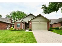 Charming single-story home with a well-manicured lawn and attached garage at 6965 Steinmeier W Dr, Indianapolis, IN 46220