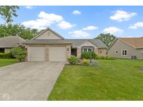 Charming single-story brick home with a well-manicured lawn, a two-car garage, and inviting curb appeal at 786 Woodview North Dr, Carmel, IN 46032