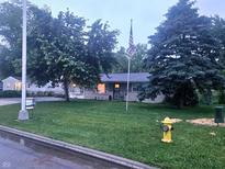 Ranch home with large front yard, mature trees, and American flag at 9470 N Old Port Royal, Martinsville, IN 46151