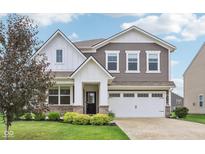 Charming two-story home featuring a well-manicured lawn, white trim, and a two-car garage at 9498 Tobin Cir, Avon, IN 46123