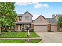 Charming home featuring a well-manicured lawn, brick facade, and a three-car garage with a basketball hoop at 10758 Gettysburg Pl, Carmel, IN 46032