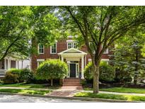 Charming brick two-story home with a well-manicured lawn and lush landscaping, creating an inviting curb appeal at 12505 Branford St, Carmel, IN 46032