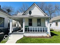 Charming house featuring a covered front porch and a well-maintained lawn at 1358 Hiatt St, Indianapolis, IN 46221