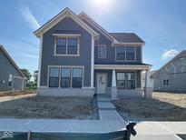 Charming two-story home featuring a stylish gray exterior, white trim, and large windows for ample natural light at 13646 Grand Abbey Way, Fishers, IN 46037