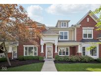 Charming brick home with a well-manicured lawn and inviting front entrance at 15553 Portland Dr, Westfield, IN 46074