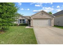 Charming single-story home featuring a brick facade, well-maintained lawn, and a two-car garage on a sunny day at 1896 Central Park W Blvd, Greenwood, IN 46143