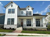 Modern two-story home with white siding, black trim, and stone accents on the porch columns at 20005 Gansett Rd, Westfield, IN 46074