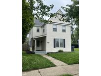Traditional two-story home featuring a quaint front porch and well-maintained lawn at 2244 Lafayette St, Anderson, IN 46012