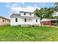 Charming two-story home features a welcoming porch, landscaped yard, and bright white siding at 2413 Fowler St, Anderson, IN 46012