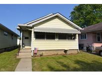 Charming bungalow with a well-maintained lawn, awning, and a quaint American flag display at 2616 Jackson St, Anderson, IN 46016