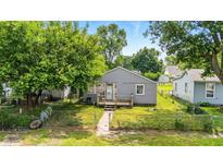 Charming gray home with a cozy front porch and a well-maintained lawn at 3251 Mars Hill St, Indianapolis, IN 46221