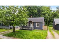 Charming single-story home featuring a covered front porch and mature landscaping at 3422 Hillside Ave, Indianapolis, IN 46218