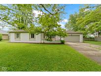 Charming single-story home with a well-manicured lawn and an attached two car garage at 3841 Meridee Dr, Indianapolis, IN 46237