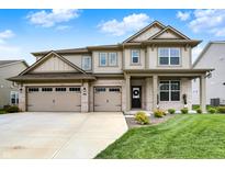 Charming two-story home with a three-car garage, beautiful brick accents, and a well-manicured lawn under a bright blue sky at 4250 Blackford Rd, Bargersville, IN 46106