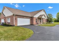 Beautiful brick home featuring an attached two car garage and manicured lawn at 4295 Washington Blvd, Plainfield, IN 46168
