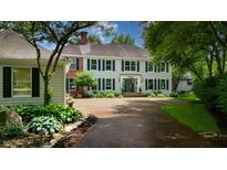 Beautiful two-story home with a long driveway, attractive landscaping, and a blend of brick and light gray siding at 4443 Mallard Pt, Columbus, IN 47201