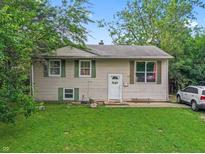 Charming two-story home featuring a well-manicured lawn and beautiful surrounding trees at 5614 Regency Dr, Indianapolis, IN 46224