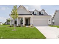 Charming new construction home with a manicured lawn and a two-car attached garage at 5673 Stetson Dr, Whitestown, IN 46052