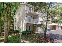 Attractive townhome with balcony, garage, and landscaping surrounded by mature trees at 6920 Wesley Ct, Indianapolis, IN 46220