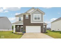 Two-story home featuring brick and gray siding, an attached two-car garage, and manicured lawn at 7834 Hillway Dr, Camby, IN 46113