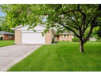 Charming single-story home with an attached garage and lush green lawn at 8022 Hoover Ln, Indianapolis, IN 46260
