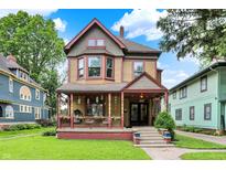 Charming two-story home with a welcoming porch and well-maintained lawn at 838 Woodruff Place West Dr, Indianapolis, IN 46201