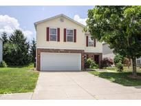 Charming two-story home featuring a brick-accented front and attached two car garage at 9215 Stones Bluff Pl, Indianapolis, IN 46113